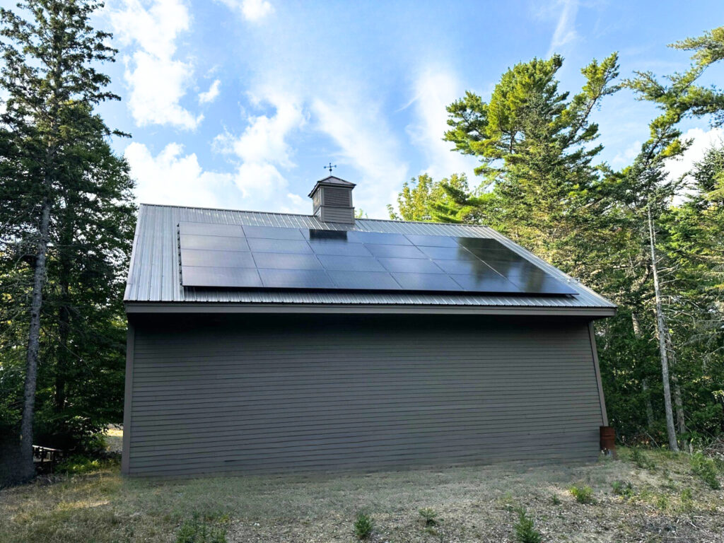 Small house with new solar panels on the roof